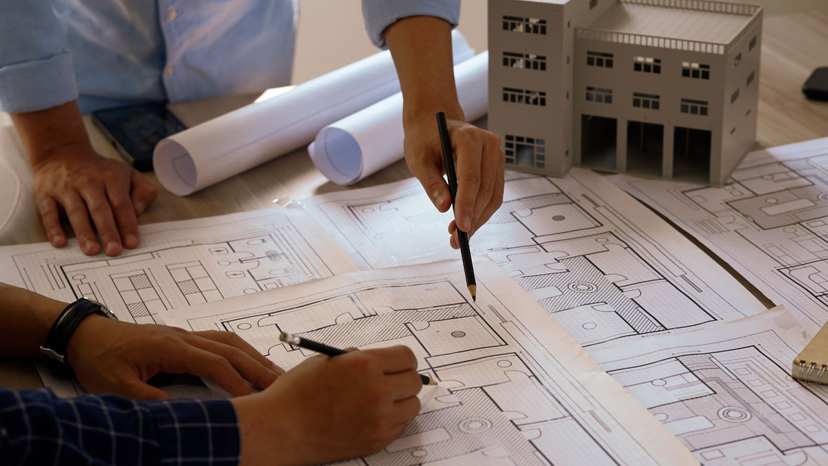 AI-native commerce organizational design represented through collaborative planning and architectural blueprints.