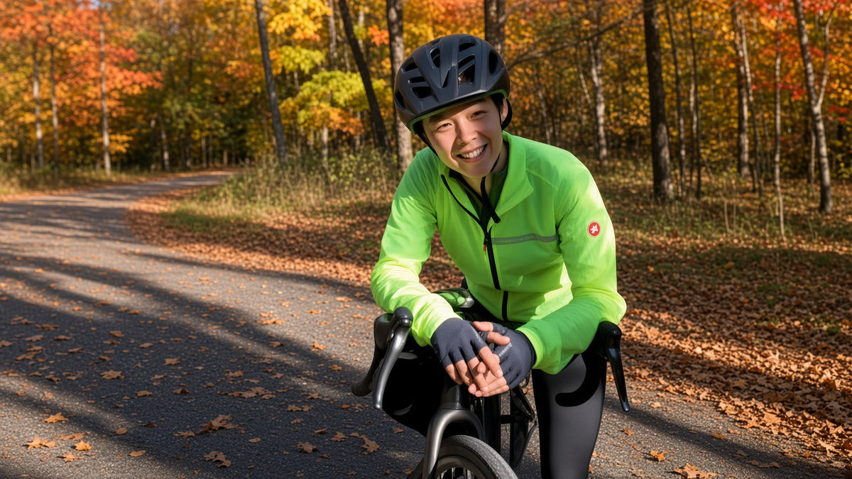Ida Tam cycling on a wooded trail in autumn.